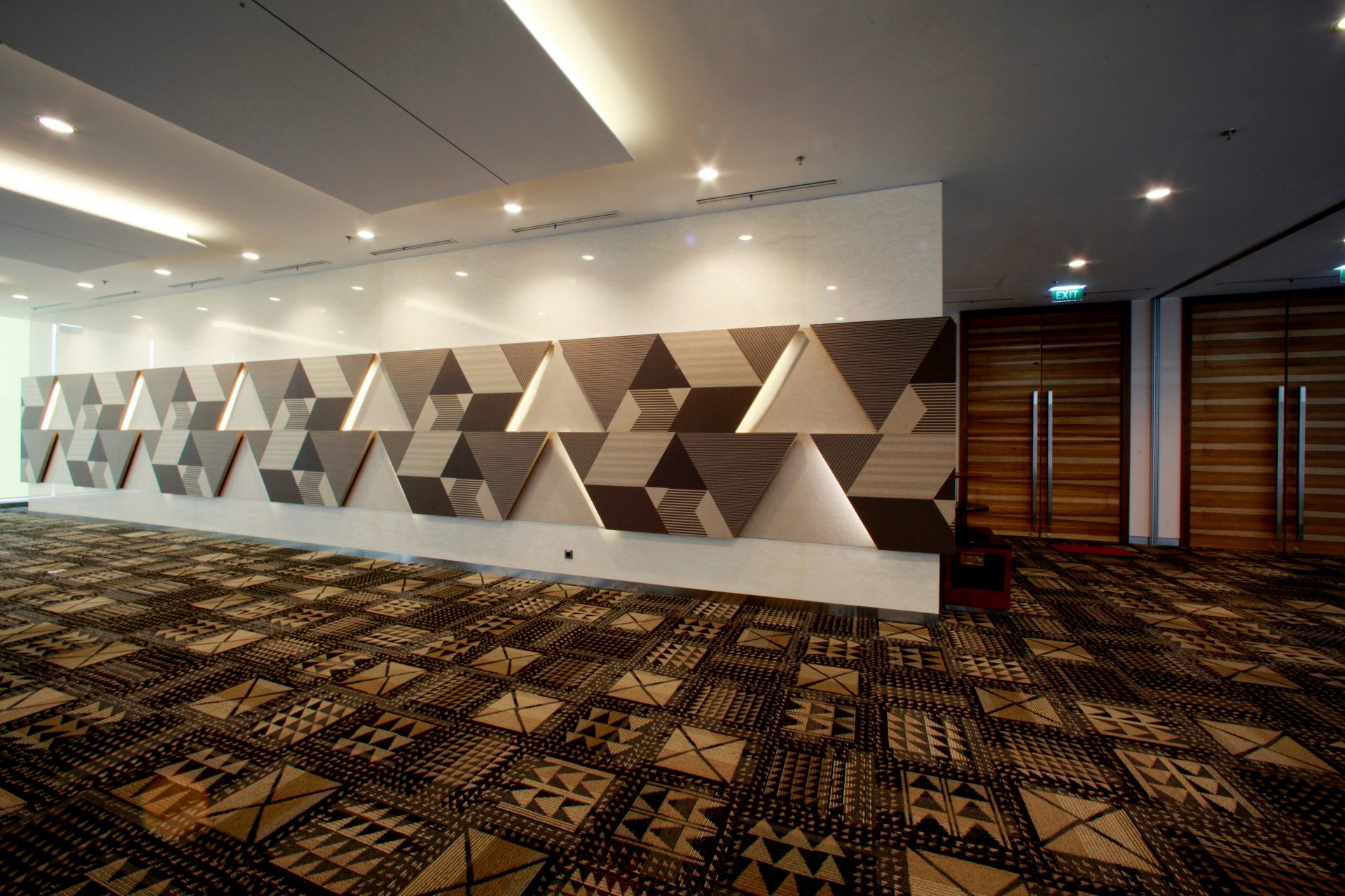 An empty room with geometric wall decoration.