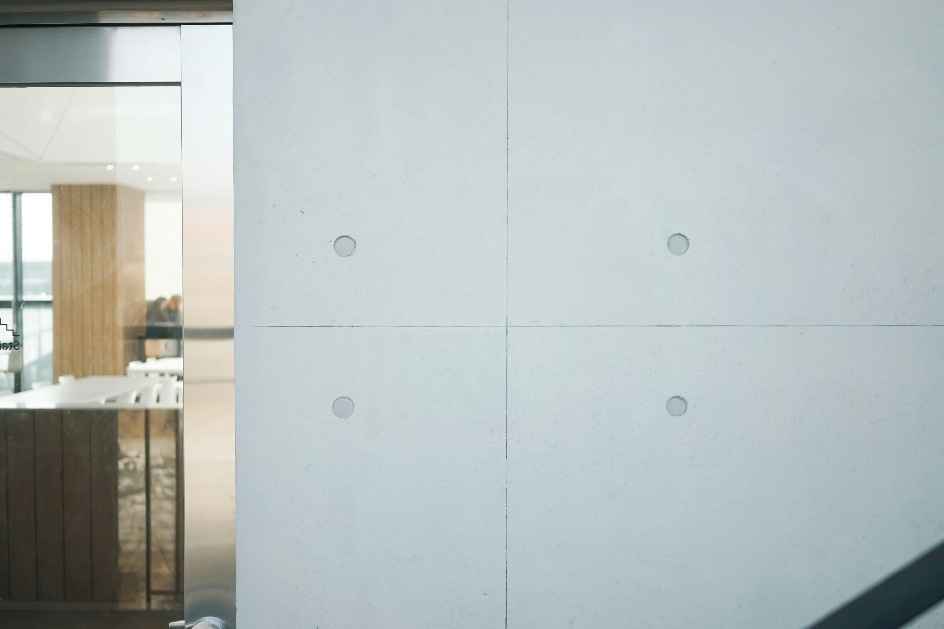 a white wall with holes in the middle of it