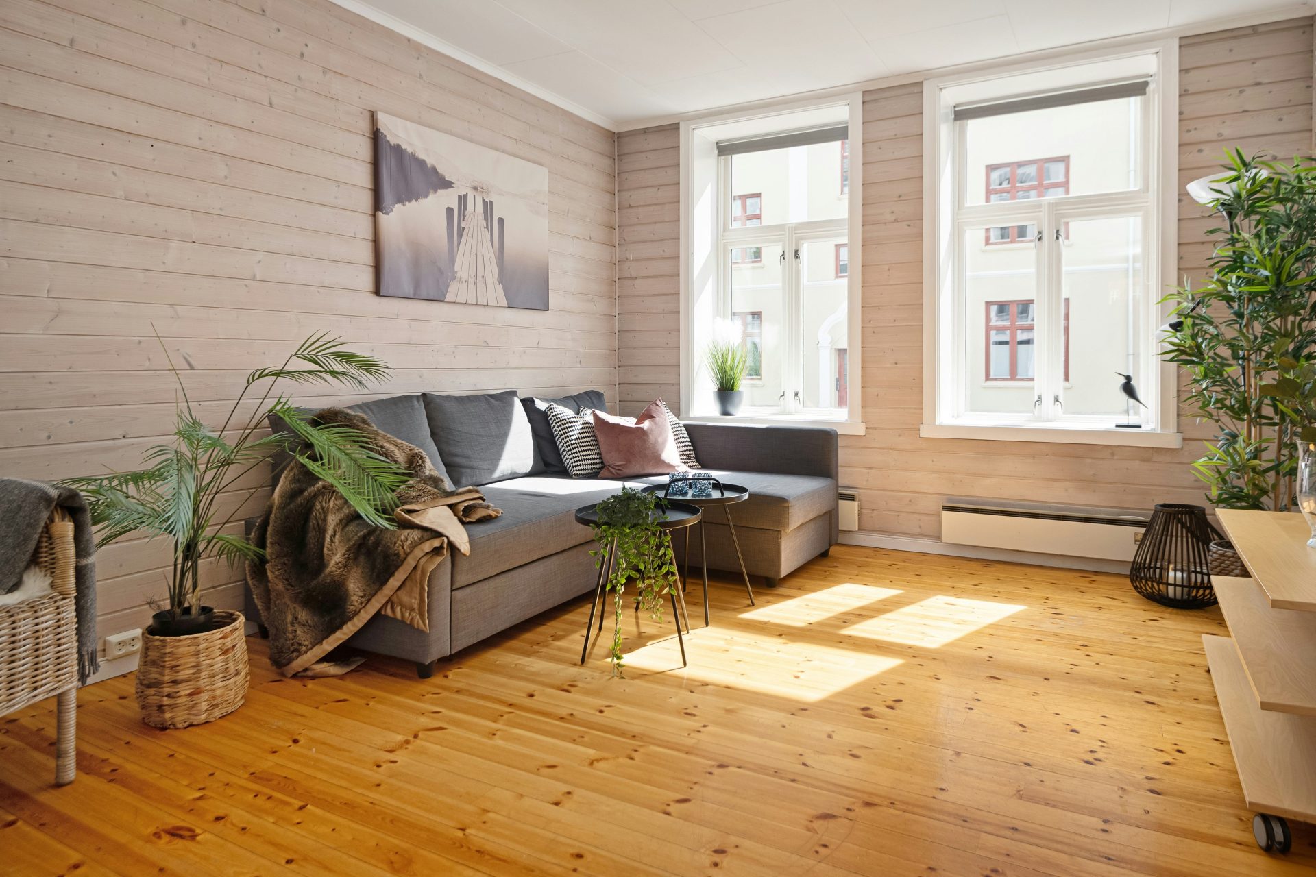 A living room filled with furniture and a wooden floor