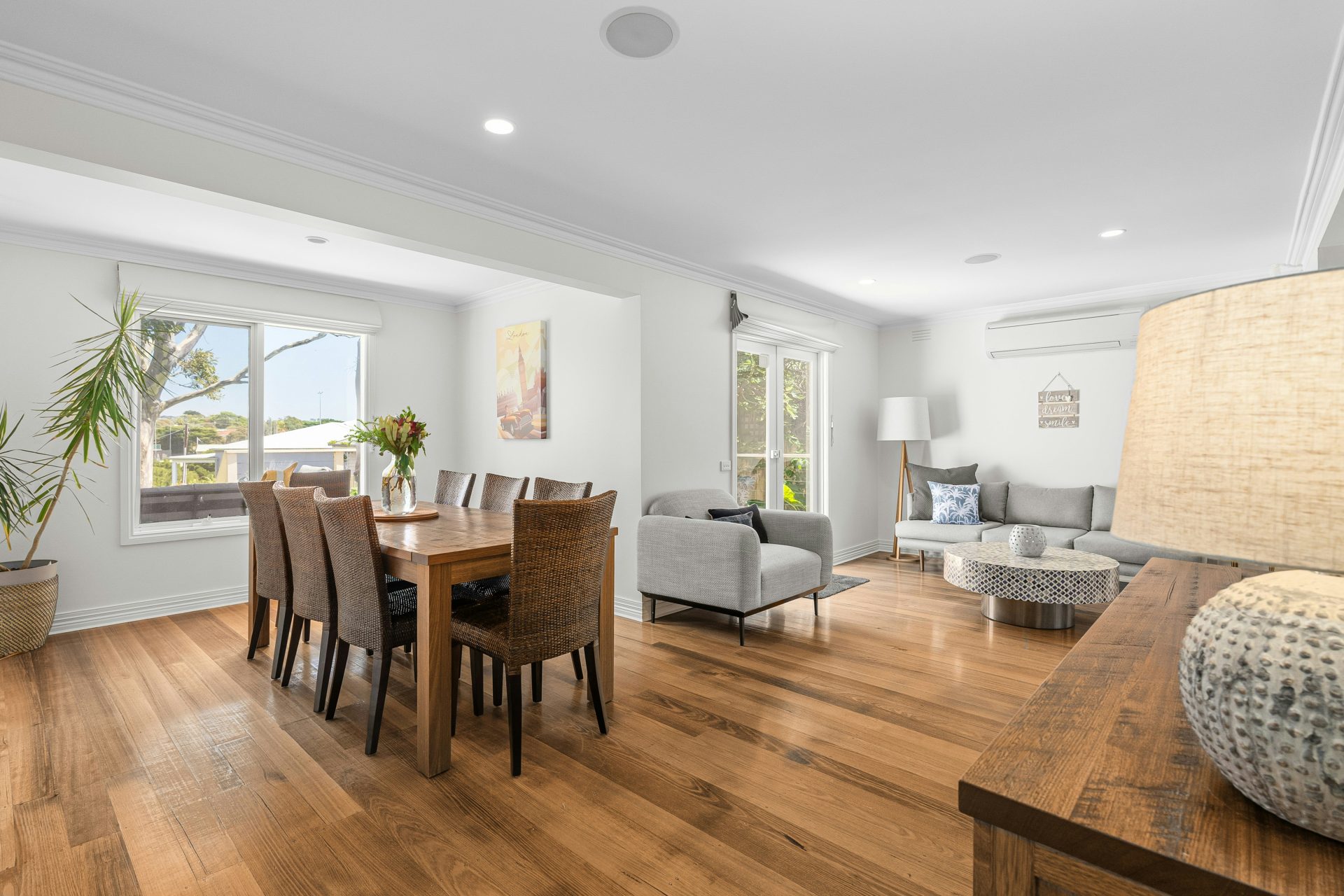 A living room and dining room with hardwood floors